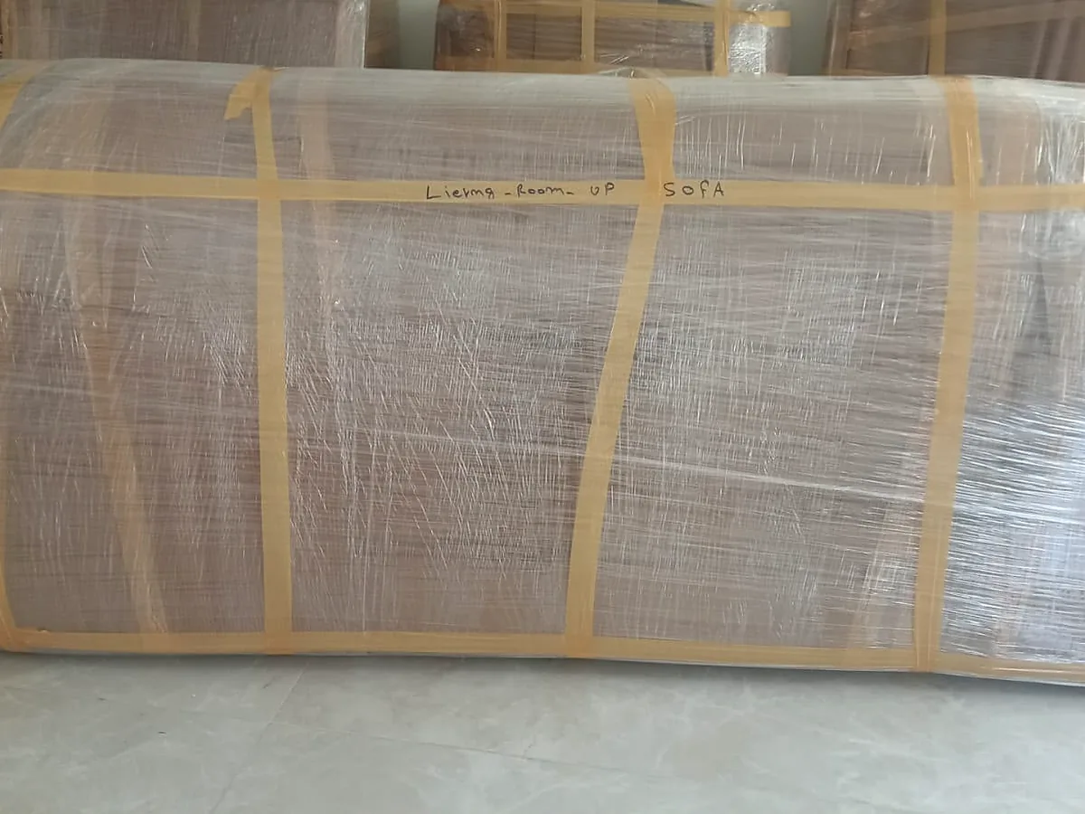 GulfNest export-packed sofa protected with stretch wrap and tape