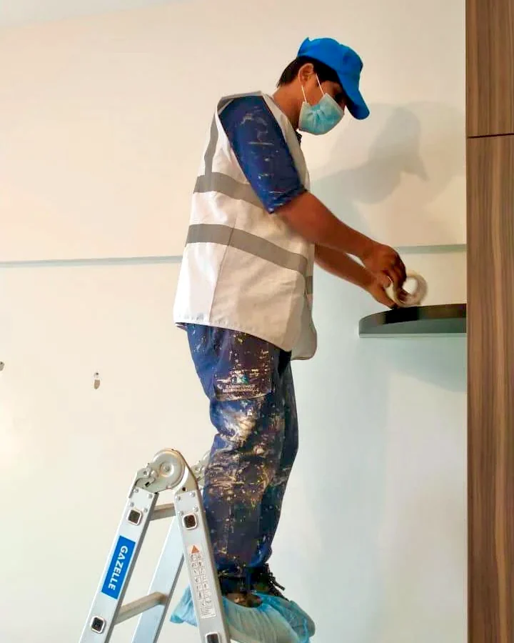 Professional painter completing masking and finishing work for GulfNest in the UAE